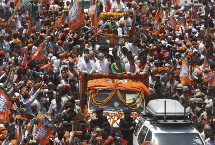 (File) Narendra Modi, prime ministerial candidate for Bharatiya Janata Party, waves to his supporters as he arrives to file his nomination papers for the general elections in Varanasi on April 24, 2014. Reuters